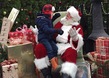 John Wenstrup as Santa Claus, speaking with a child sitting on his lap