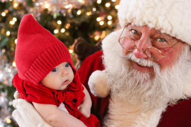 John Wenstrup as Santa Claus, holding a baby