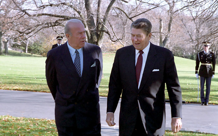 George Shultz and Ronald Reagan walking together outdoors