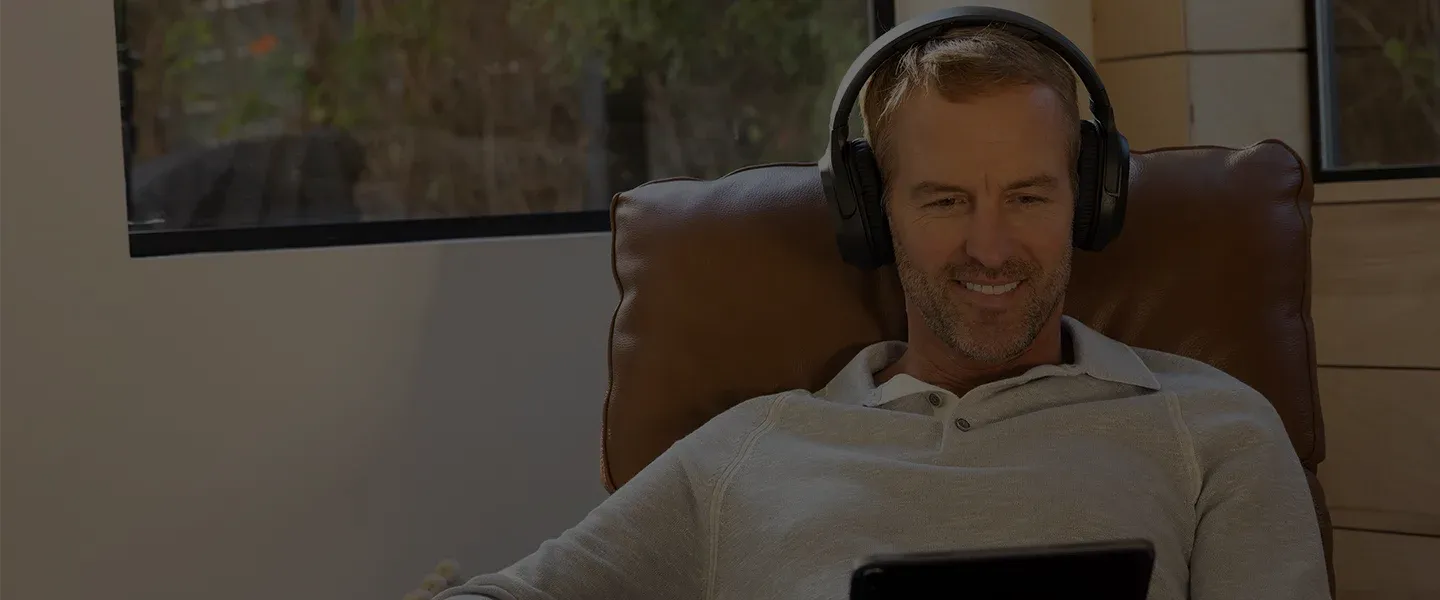 Closeup of Gunner with headphones and tablet taking Eargo's hearing screener