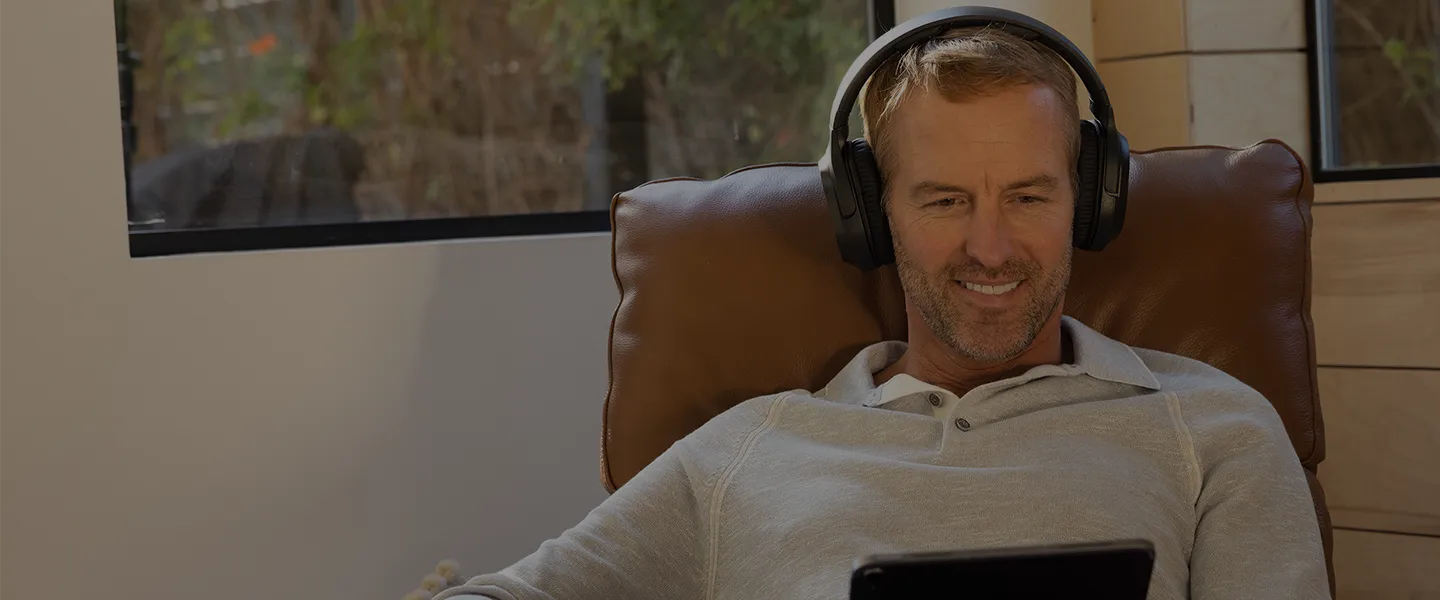Closeup of Gunner with headphones and tablet taking Eargo's hearing screener